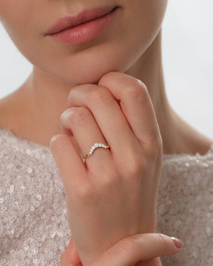 Celestial nesting wedding band worn on a hand held under the chin