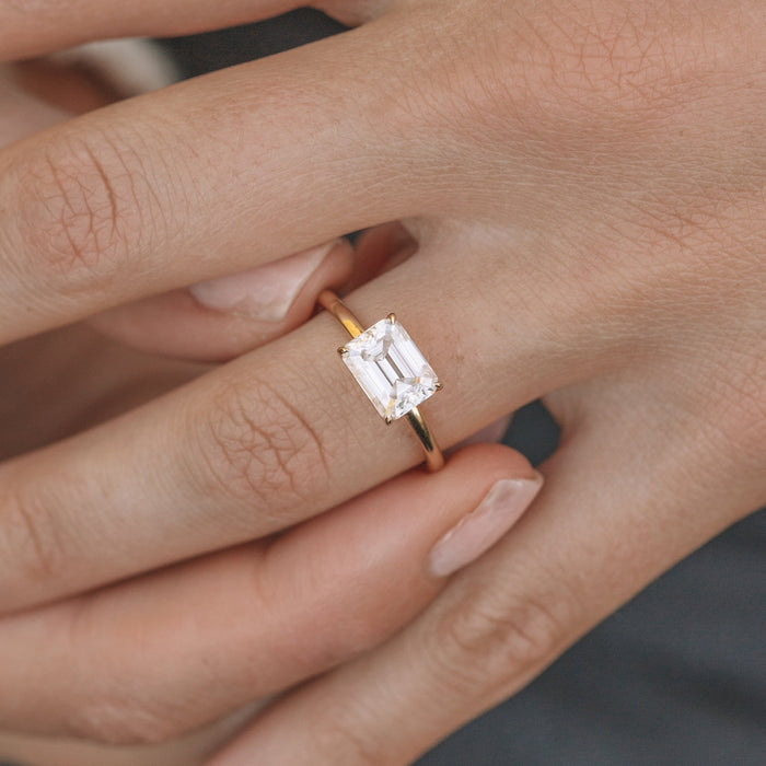 Emerald Cut Moissanite East West Four Prong Solitaire Engagement Ring - on hand view 1