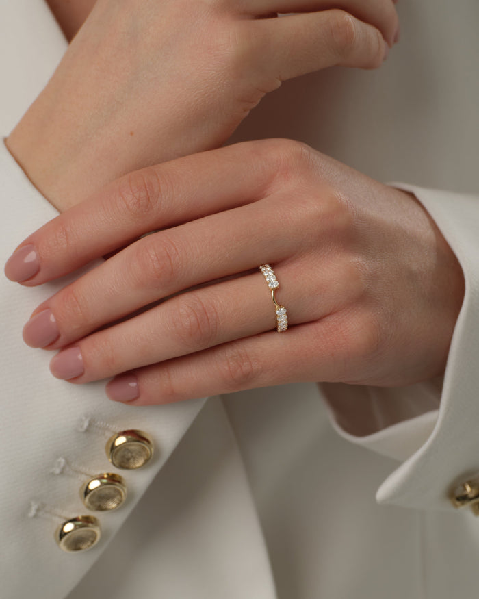 Oval moissanite curved nesting band worn with a suit jacket