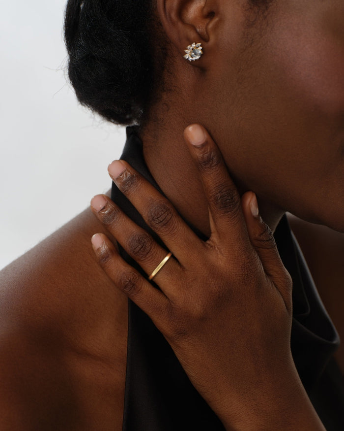 2mm dome matte gold wedding band worn on a hand
