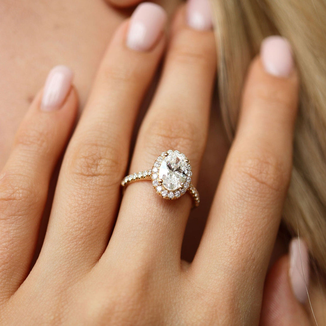 Oval cut lab grown diamond halo engagement ring with pave band