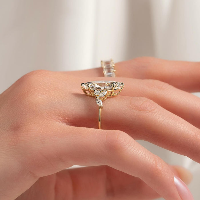 Marquise accent diamonds fanned out at both ends of the centre stone