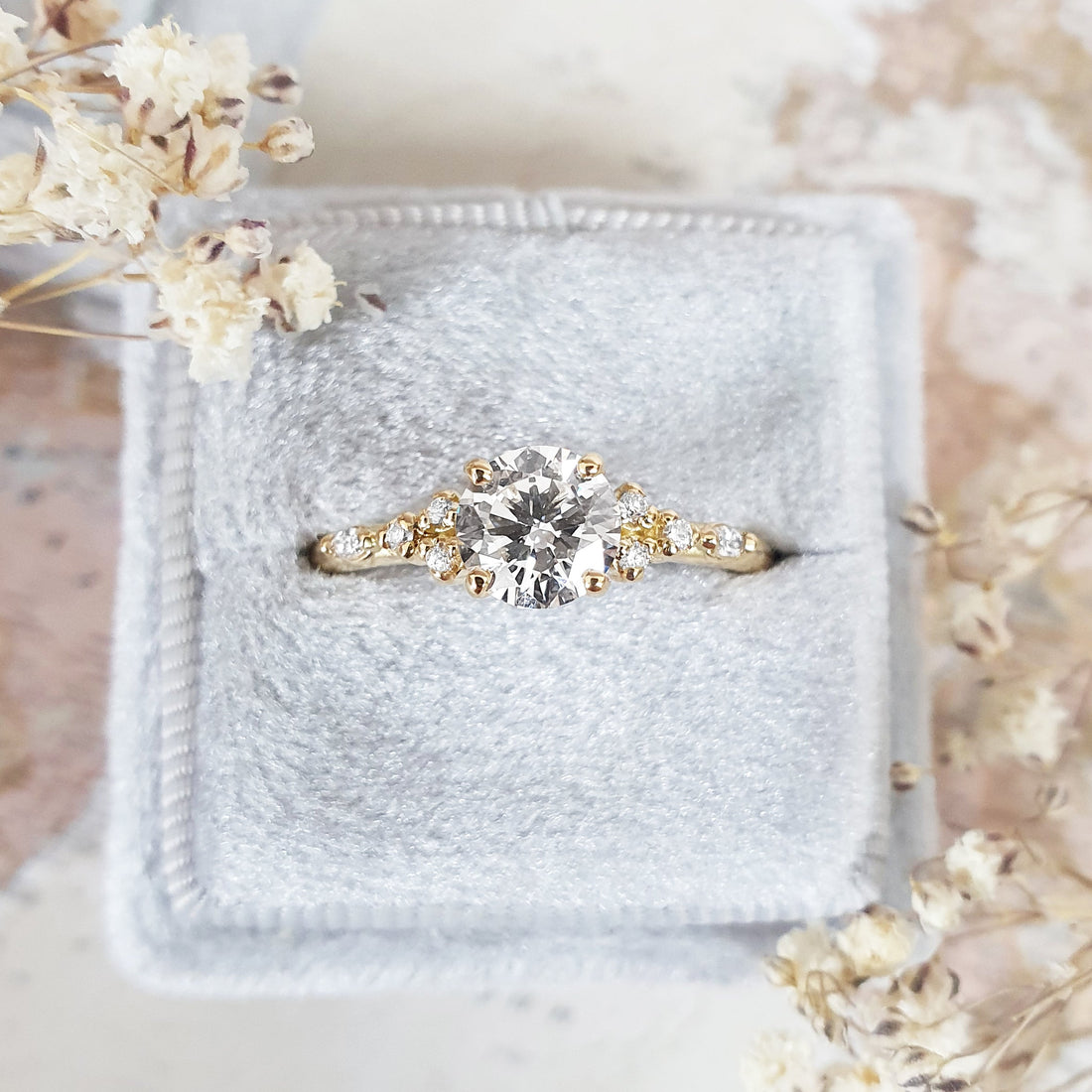 Round cut lab grown diamond ring with cluster set shoulders in yellow gold