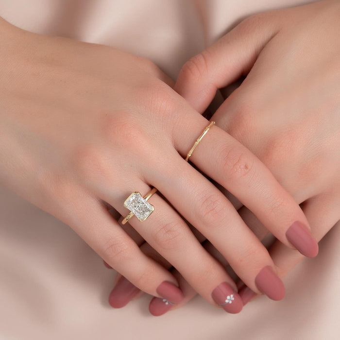 Half bezel radiant cut engagement ring worn on the hand