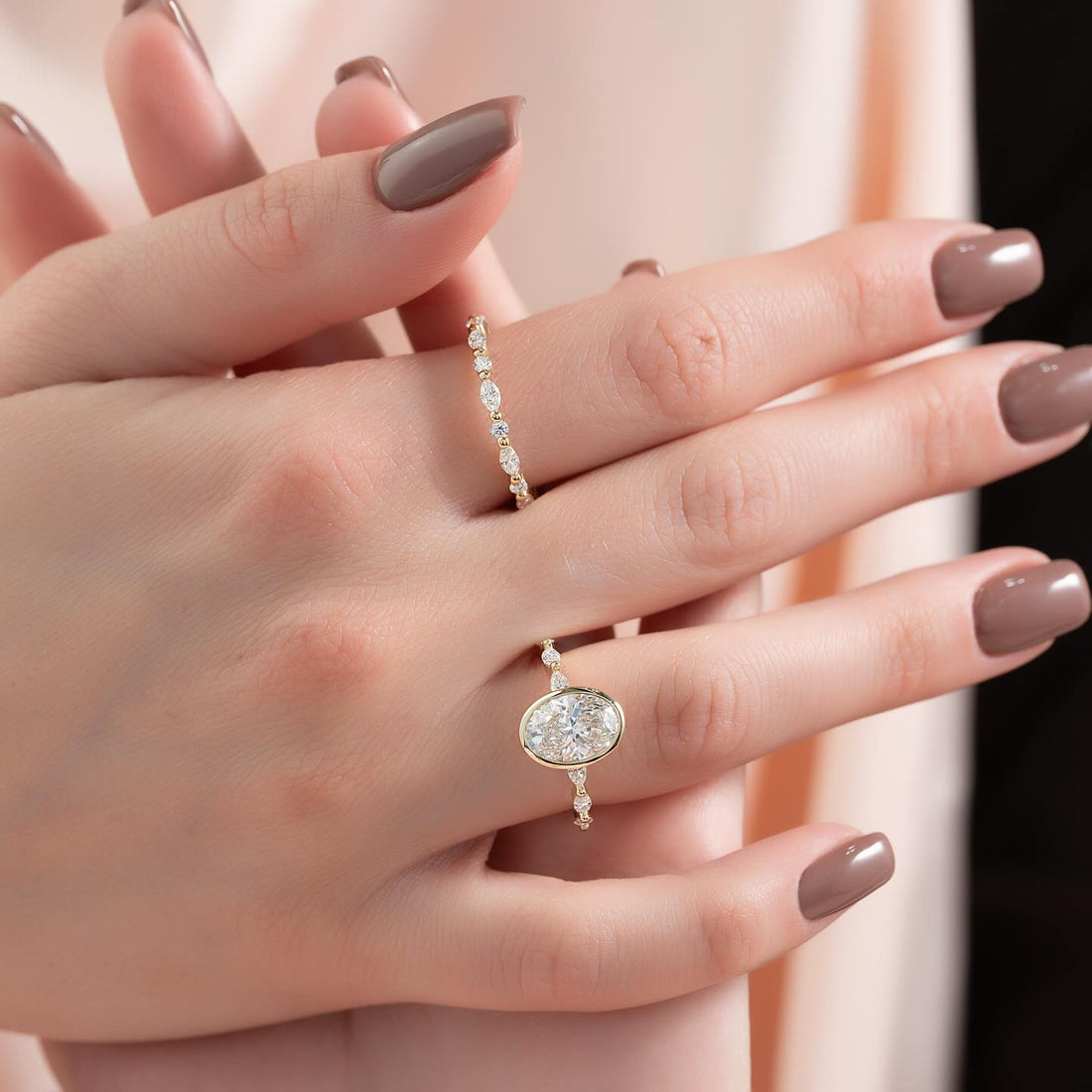 Oval lab grown diamond bezel ring with alternating marquise and round diamond band in yellow gold