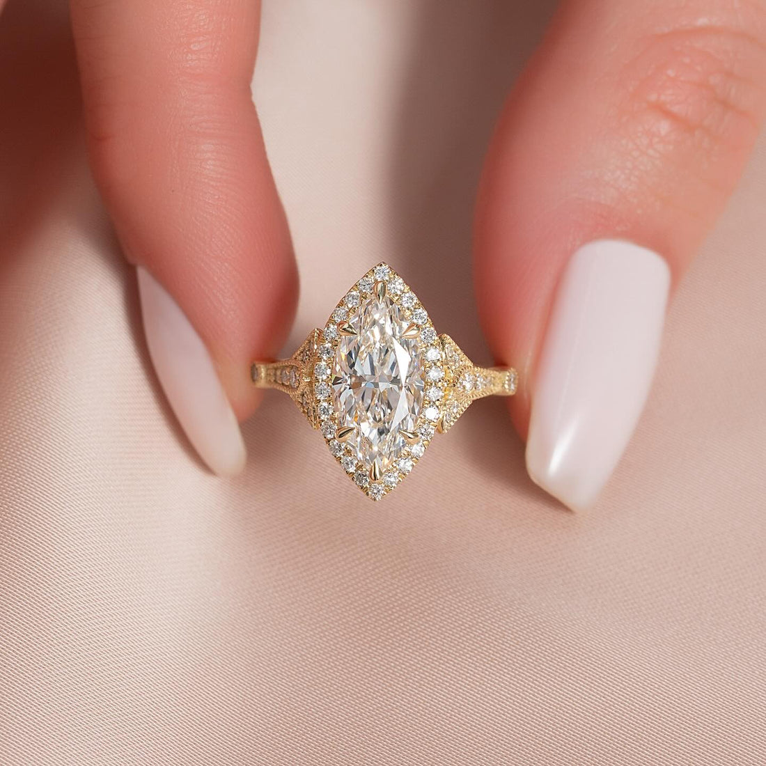 Marquise cut lab grown diamond navette halo ring with milgrain in yellow gold