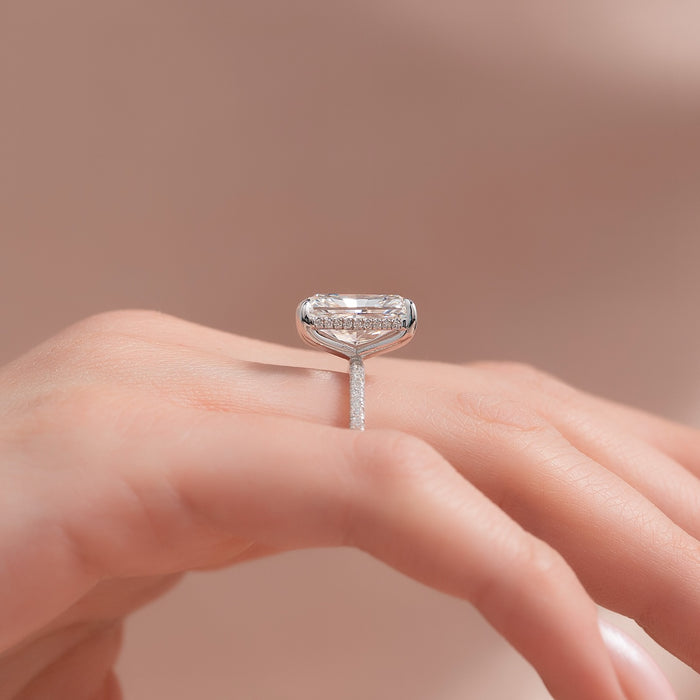 Side view of radiant moissanite hidden halo pave band ring in white gold