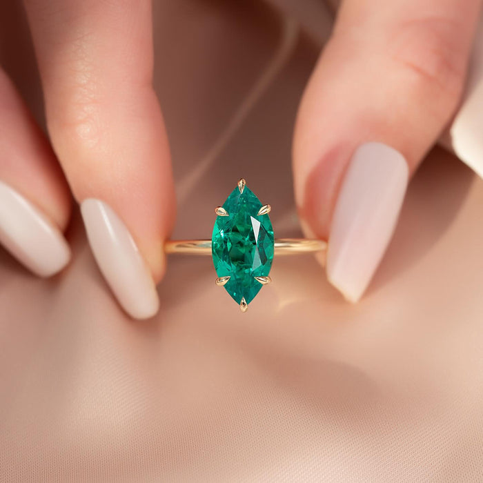 Vivid green marquise lab grown emerald in a six claw setting