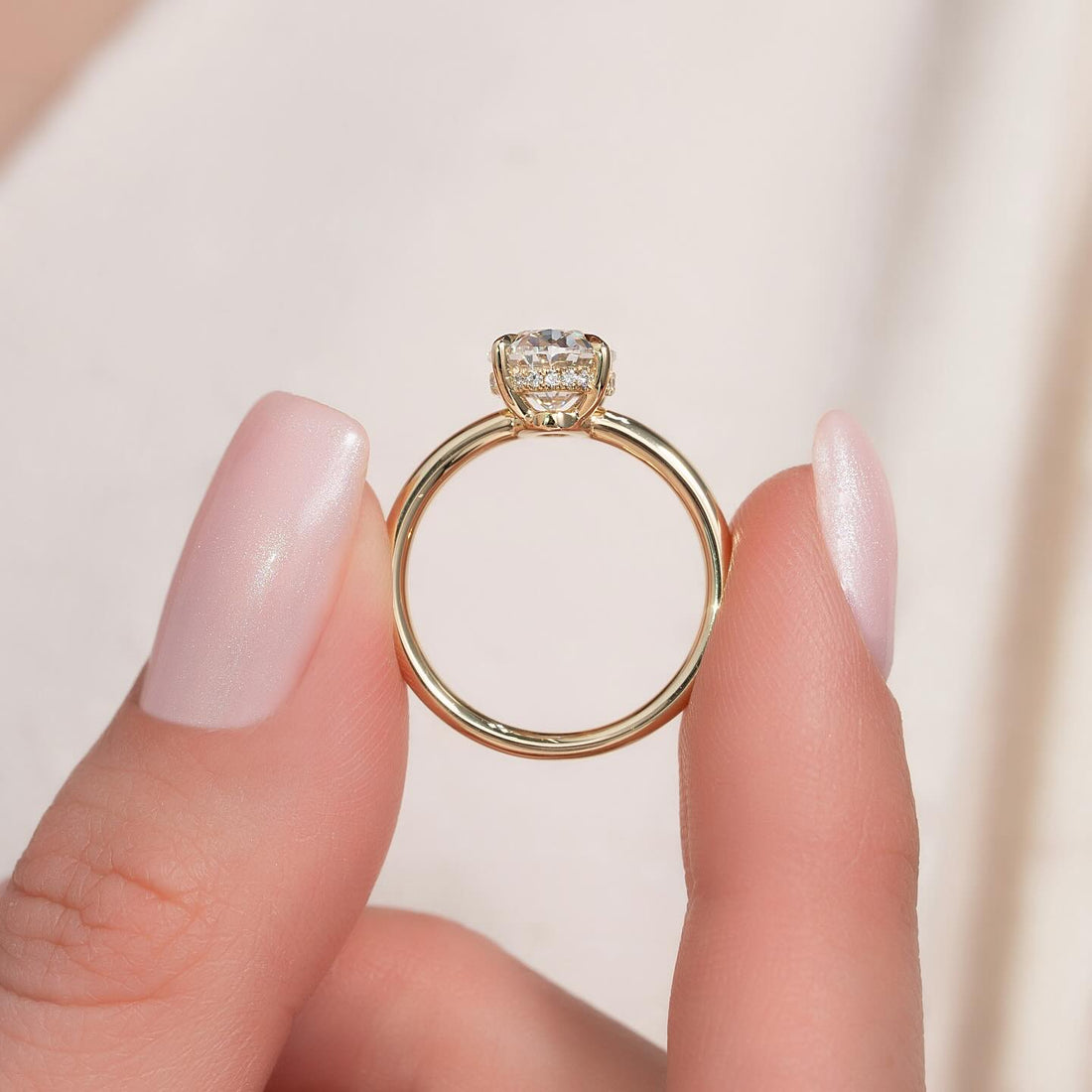 Oval moissanite hidden halo classic band ring in yellow gold