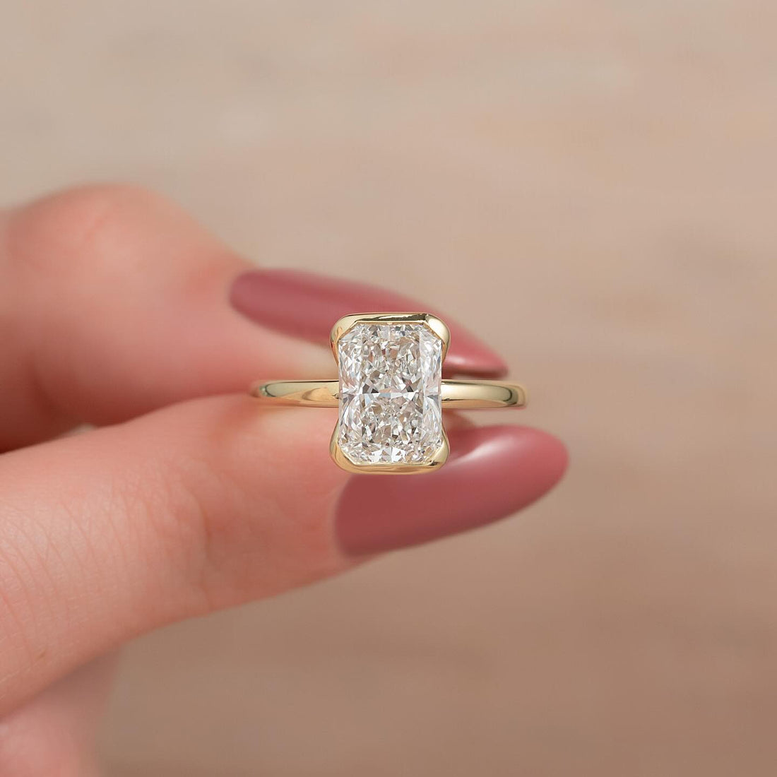 Elongated radiant cut lab grown diamond half bezel ring in yellow gold