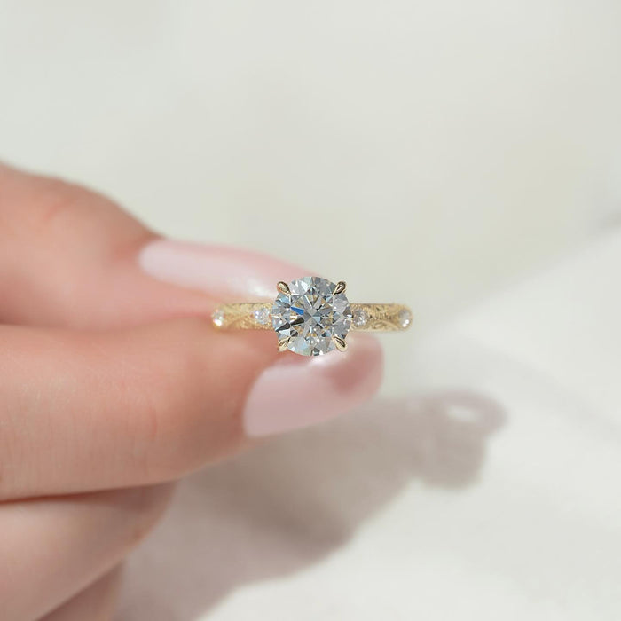 Round moissanite vintage engraved accent ring in yellow gold