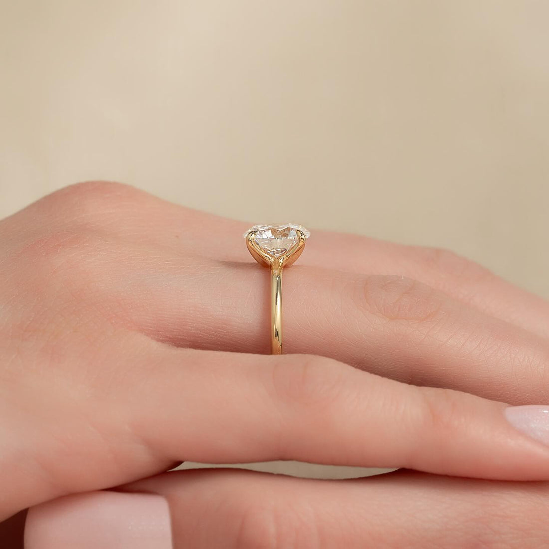 Round moissanite classic solitaire ring side view in yellow gold