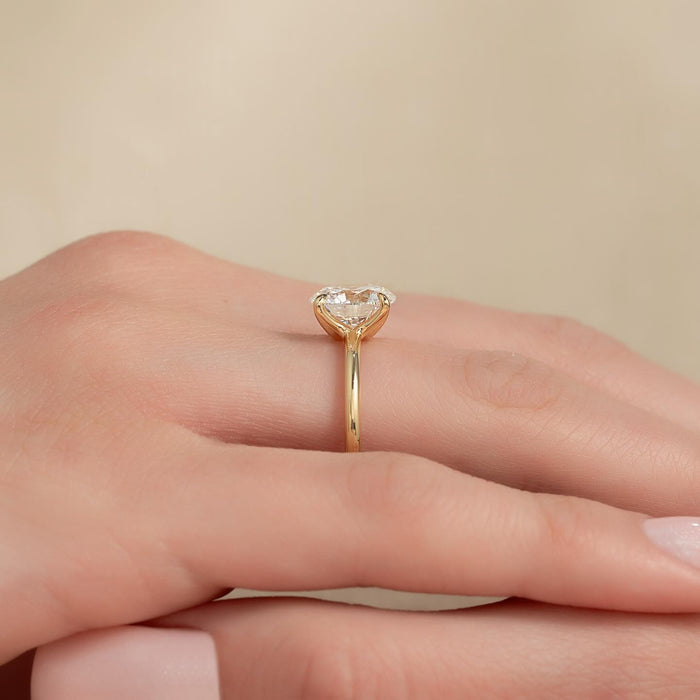 Round moissanite classic solitaire ring side view in yellow gold