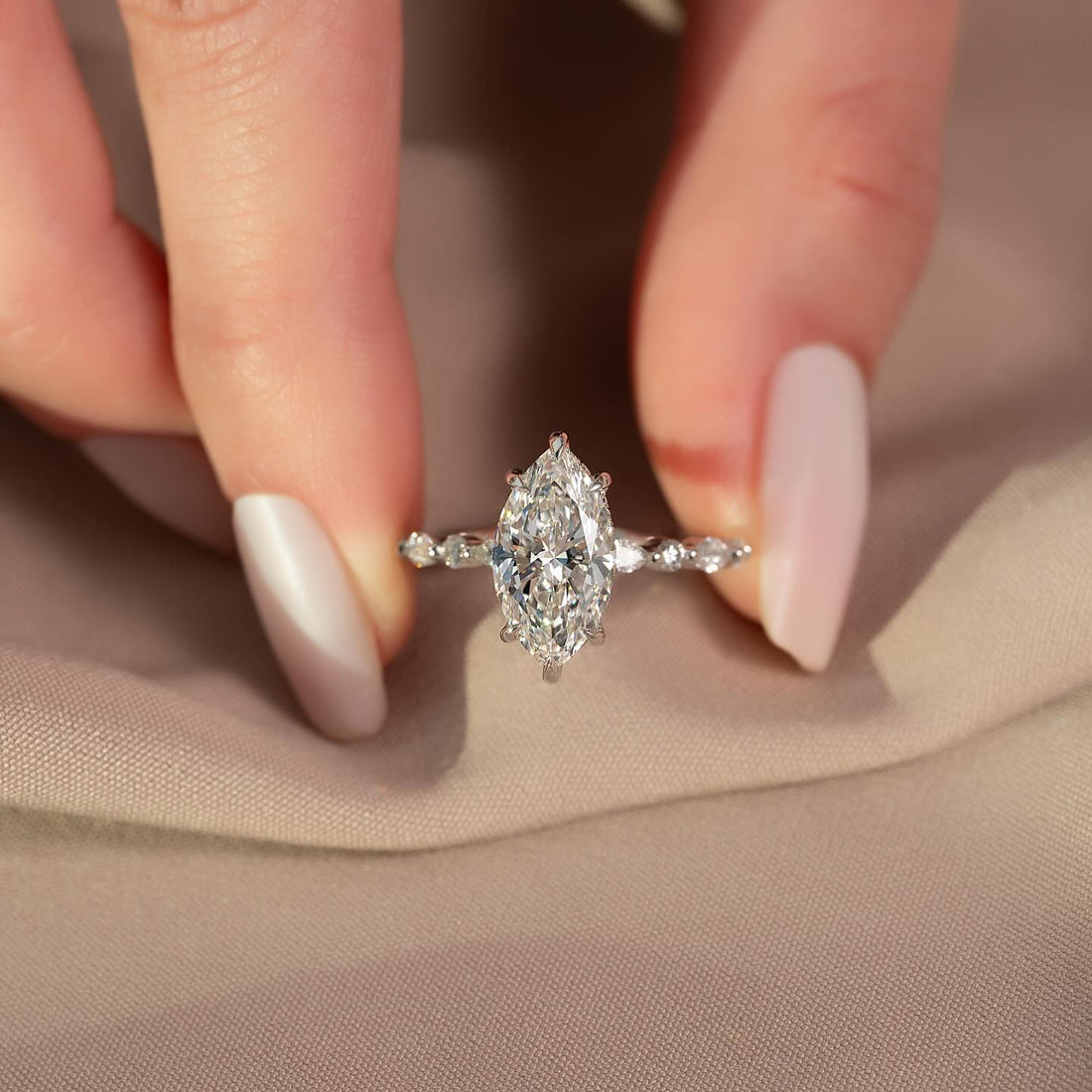 Marquise cut lab grown diamond ring with alternating marquise and round accents in white gold