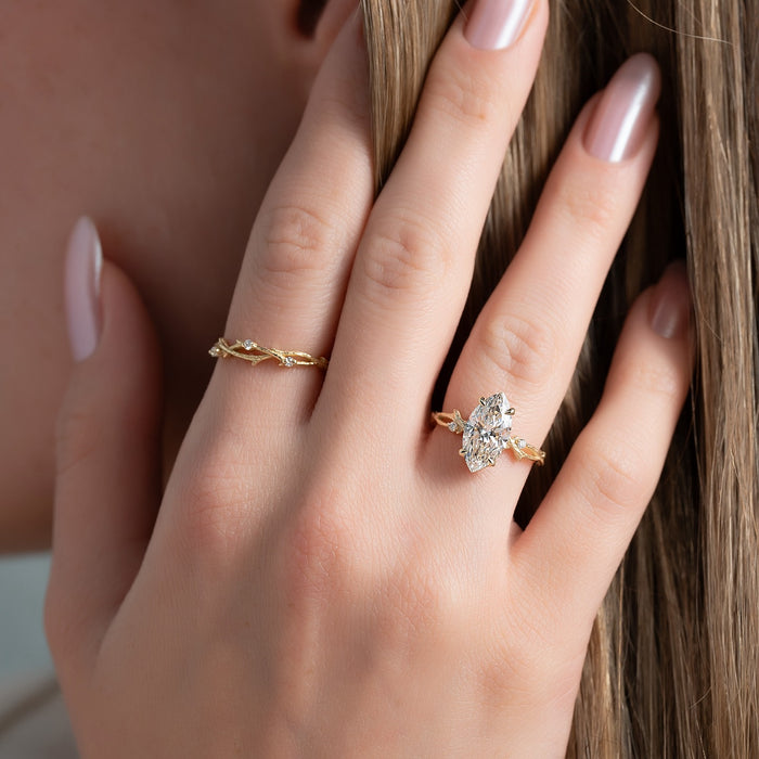 Marquise cut lab grown diamond ring with twig and leaf band in yellow gold worn on the hand