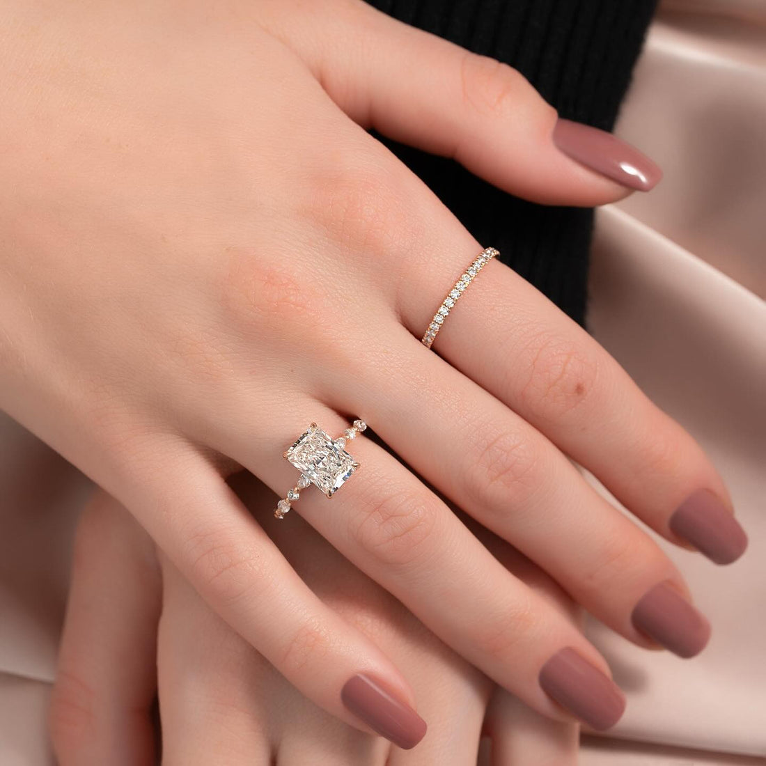 Radiant cut lab grown diamond ring with marquise station accent band worn on the hand
