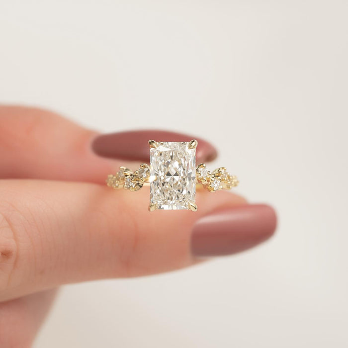 Radiant moissanite hidden halo scattered accent ring in yellow gold