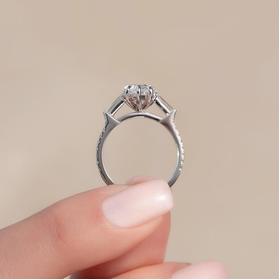 Pear moissanite tapered baguette three stone ring side view in white gold