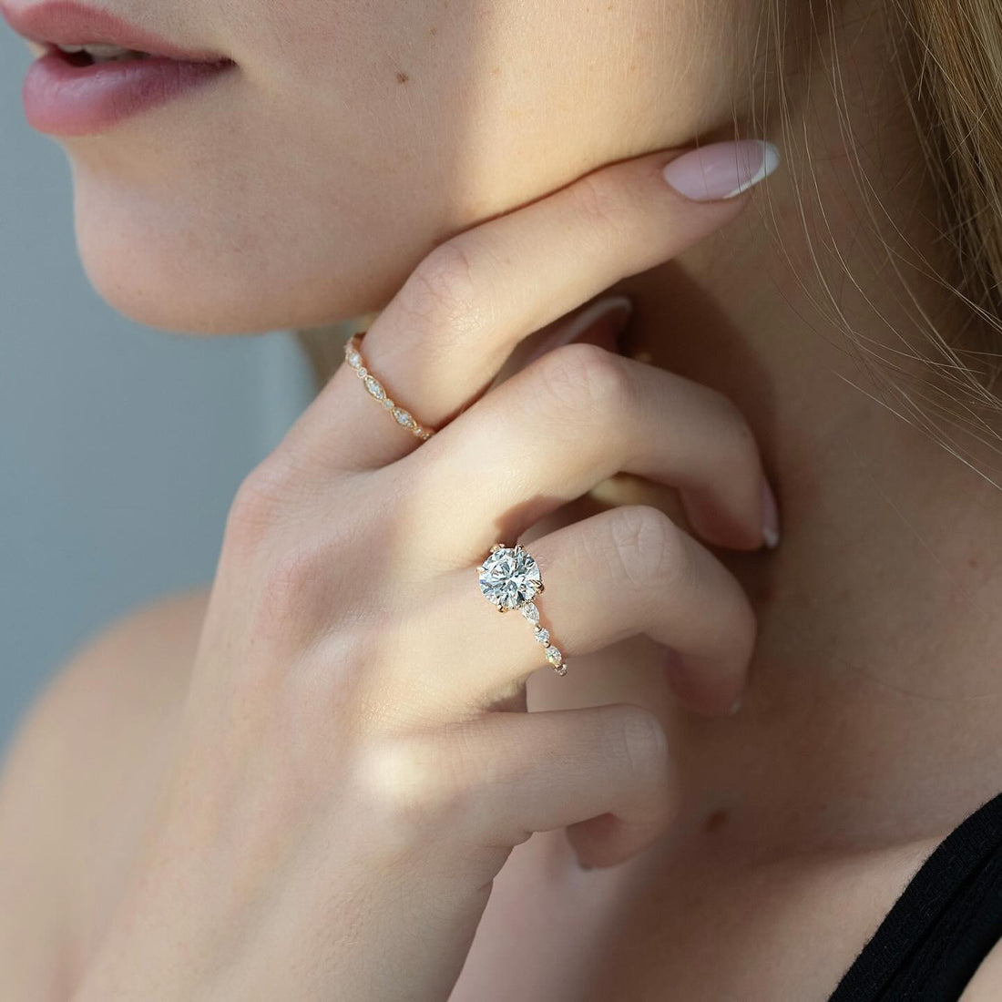 Round brilliant lab grown diamond ring in rose gold with marquise and round accents on the shoulder