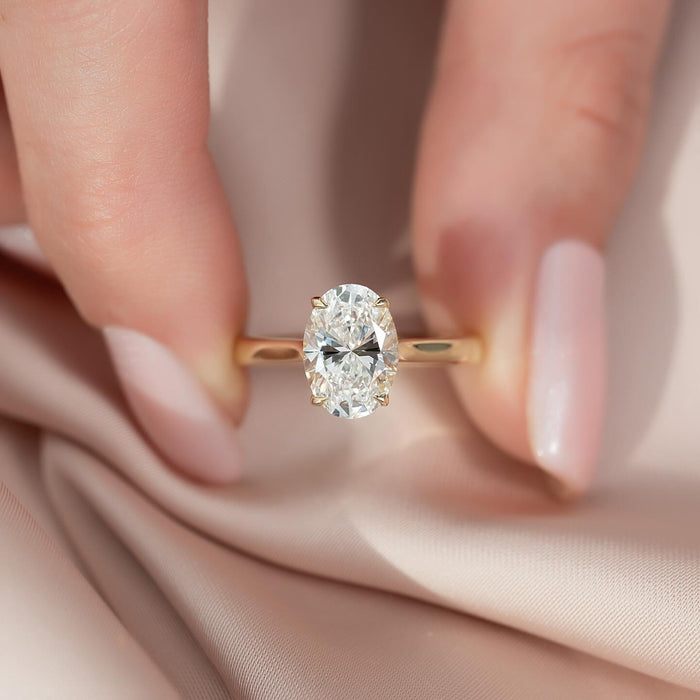 Oval cut lab grown diamond double hidden halo ring with flat edge band in yellow gold