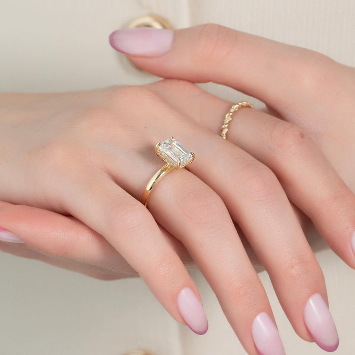 Emerald cut lab grown diamond hidden halo ring worn on the hand
