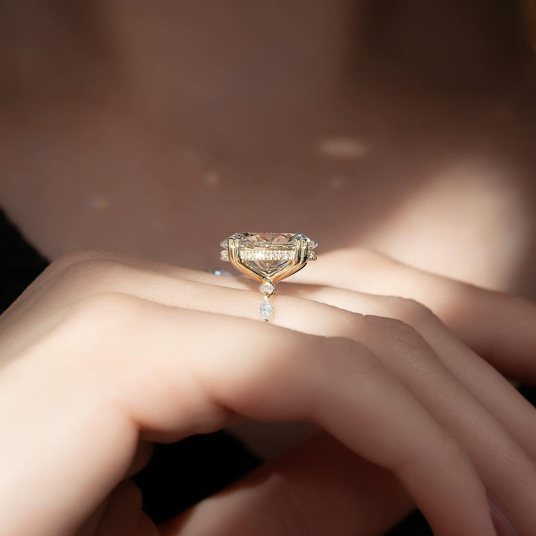 Round moissanite hidden halo marquise accent band ring side view in yellow gold