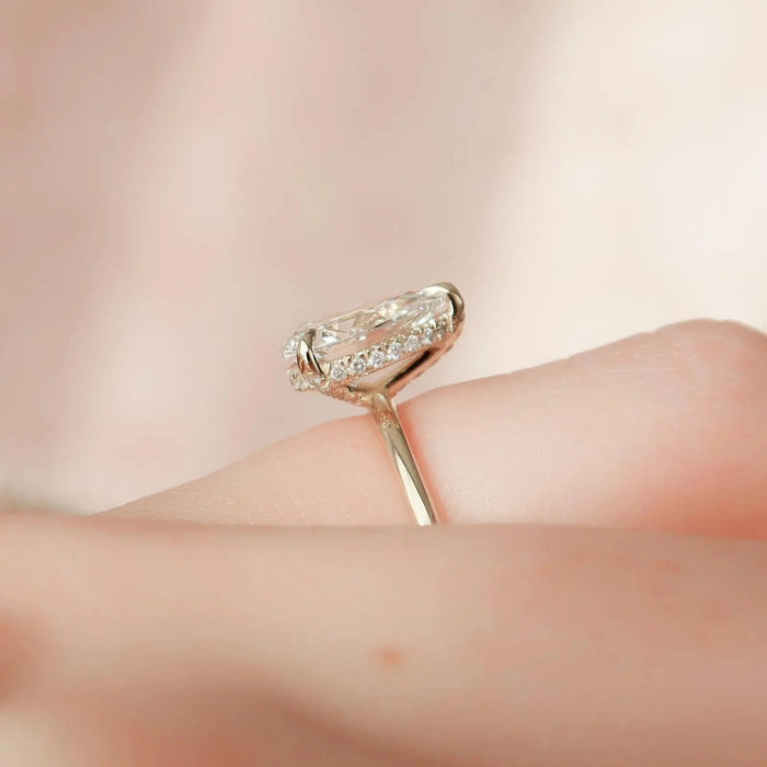 Side profile of the pear cut lab grown diamond ring showing the hidden halo beneath the basket