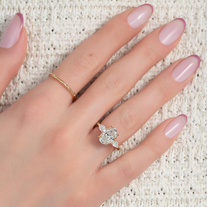 Oval three stone lab grown diamond engagement ring worn on the hand