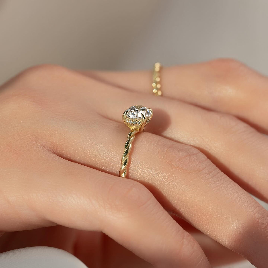 Round lab grown diamond ring on a twisted rope band in yellow gold