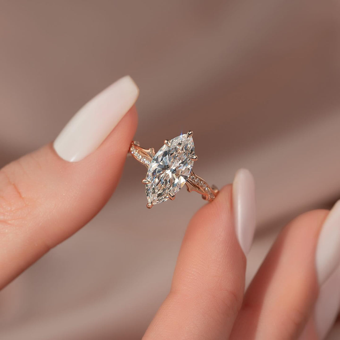 Marquise moissanite solitaire ring on a rose gold vine pave band