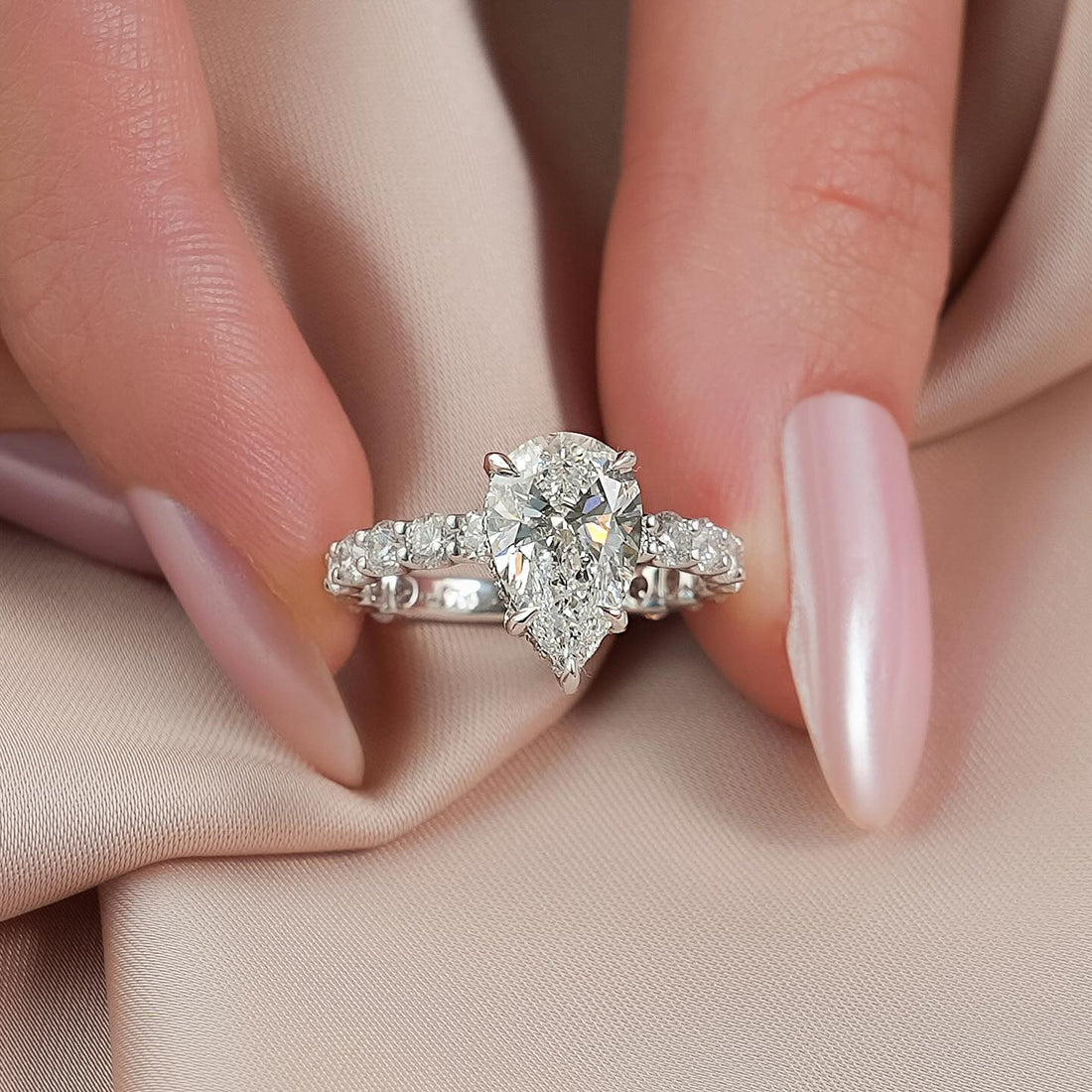 Pear cut lab grown diamond ring with shared claw eternity shank in white gold
