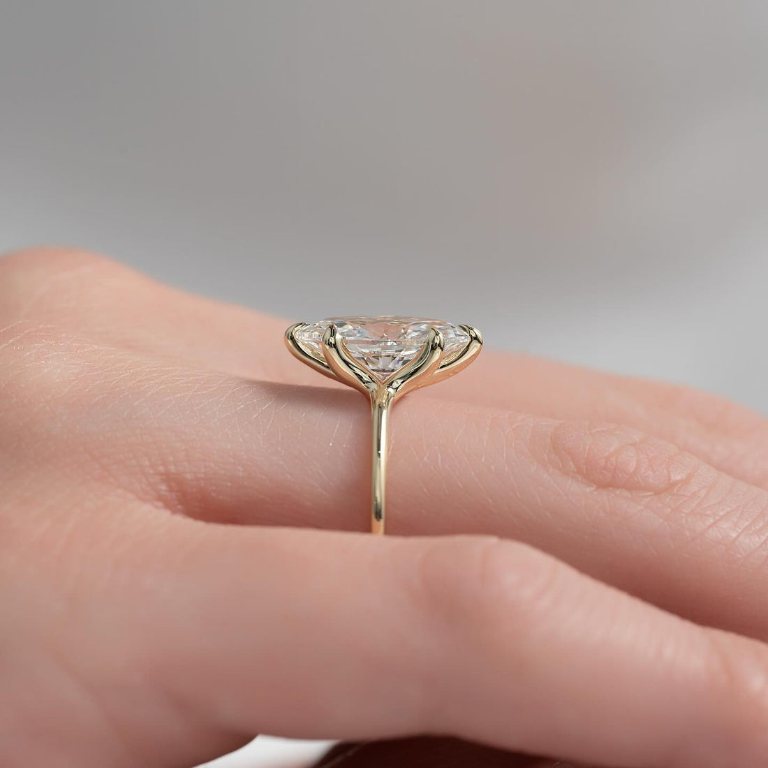 Marquise moissanite solitaire ring on a thin yellow gold band