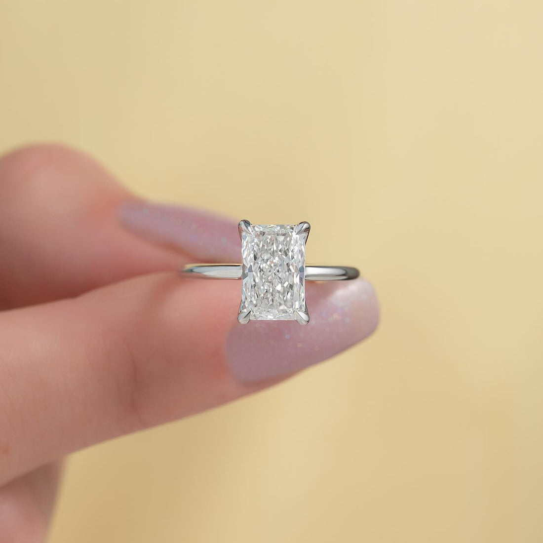 Radiant cut lab grown diamond solitaire on a knife edge white gold band, front view