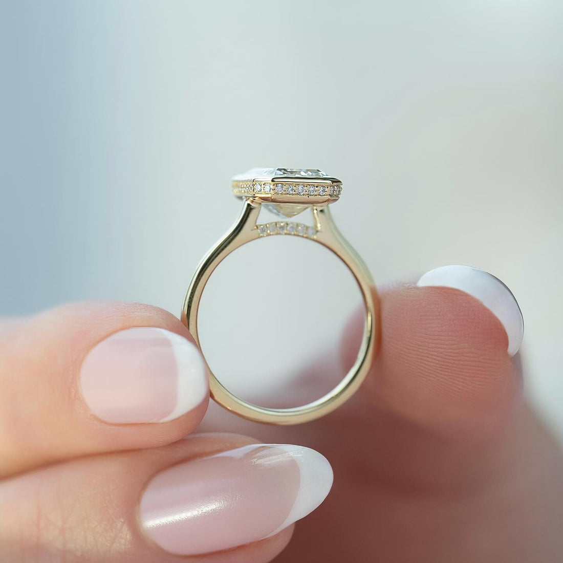 Emerald cut lab grown diamond bezel ring in yellow gold viewed from above