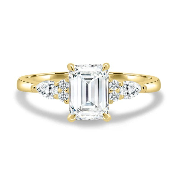 Emerald cut lab grown diamond ring with pear and round cluster shoulder accents