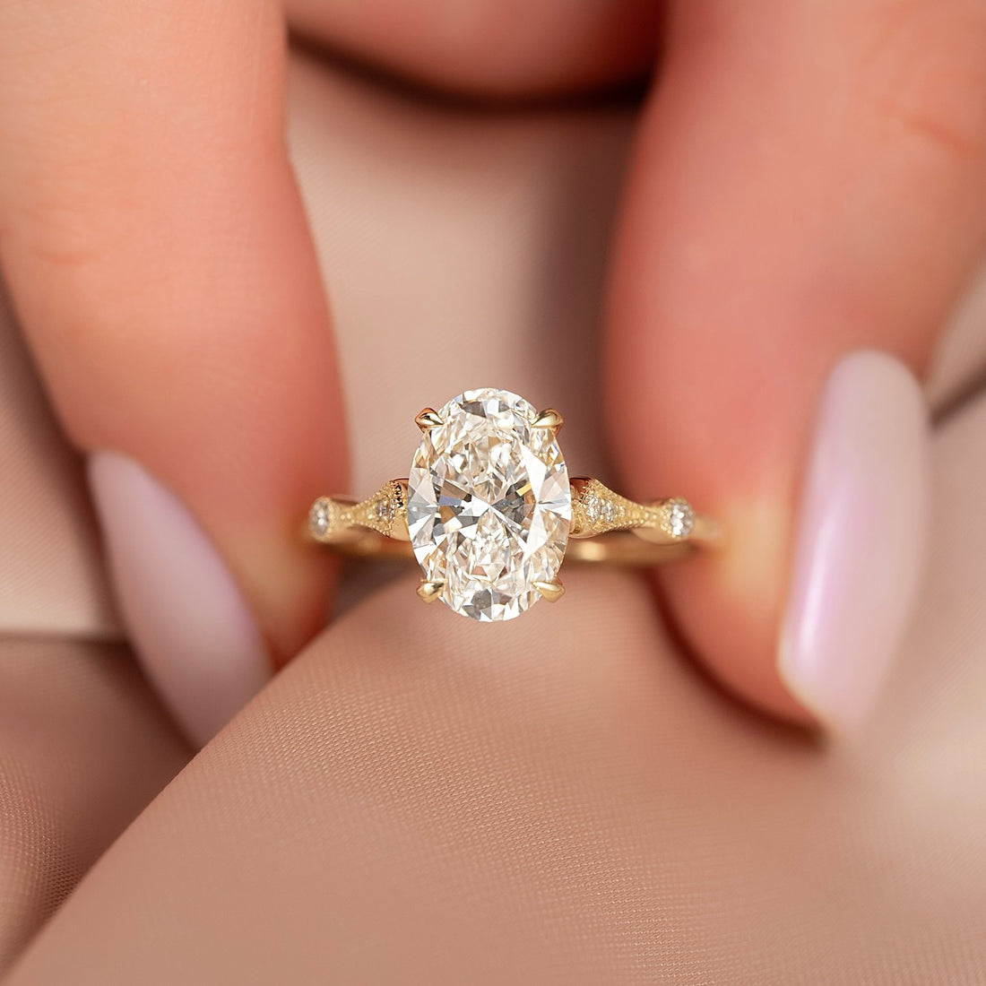 Oval lab grown diamond ring with milgrain vintage shoulders in yellow gold