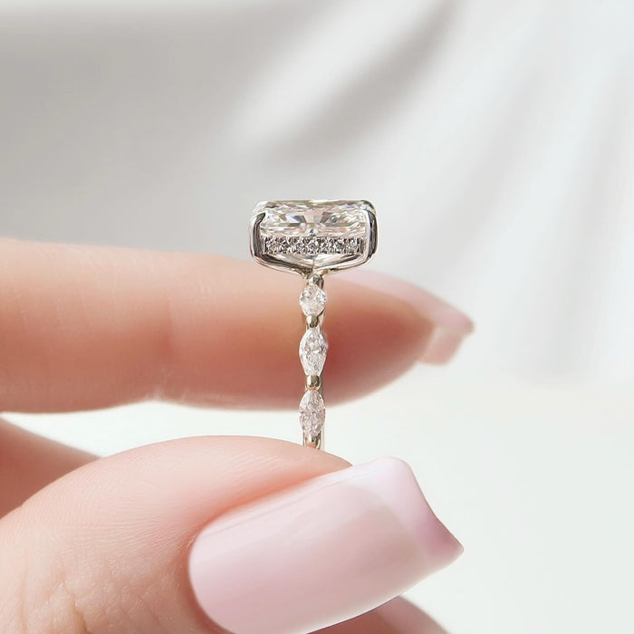 Close view of the graduated marquise accents beside the radiant cut diamond