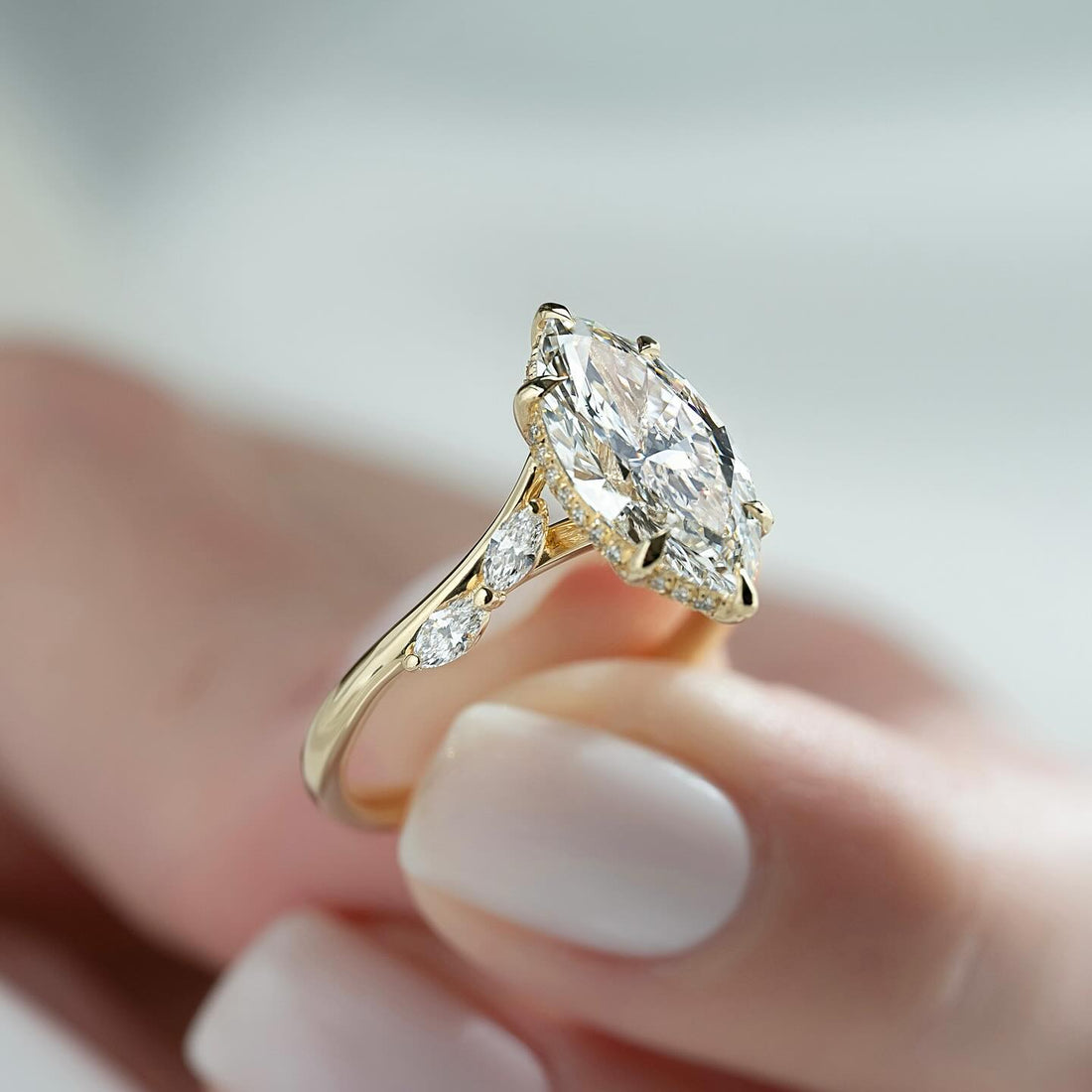 Marquise cut lab grown diamond ring in yellow gold with a milgrain edged halo