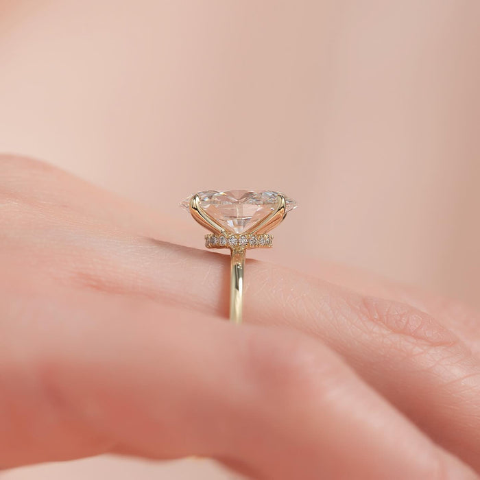 Oval moissanite east west hidden halo ring profile in yellow gold