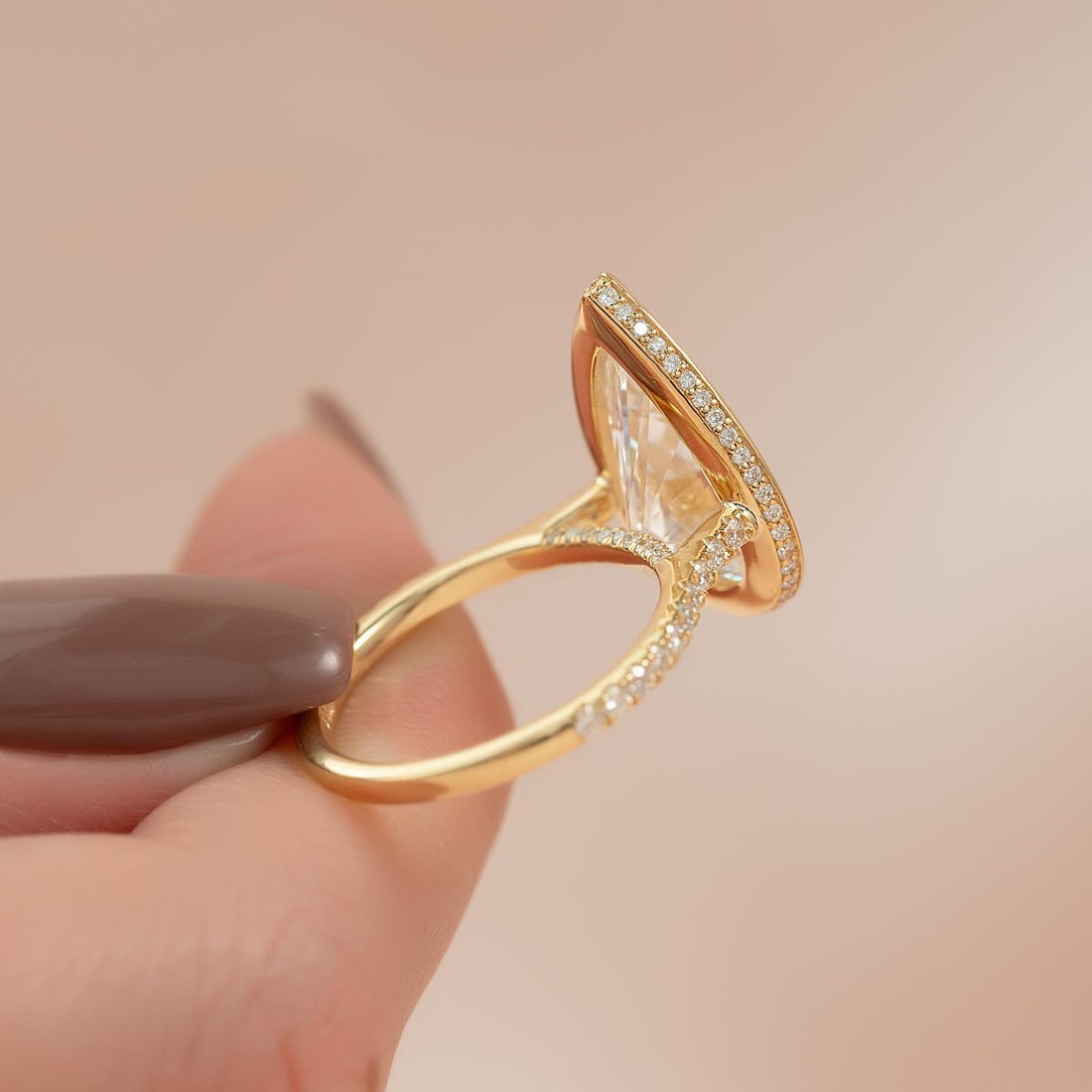 Pear moissanite bezel hidden halo ring profile in yellow gold