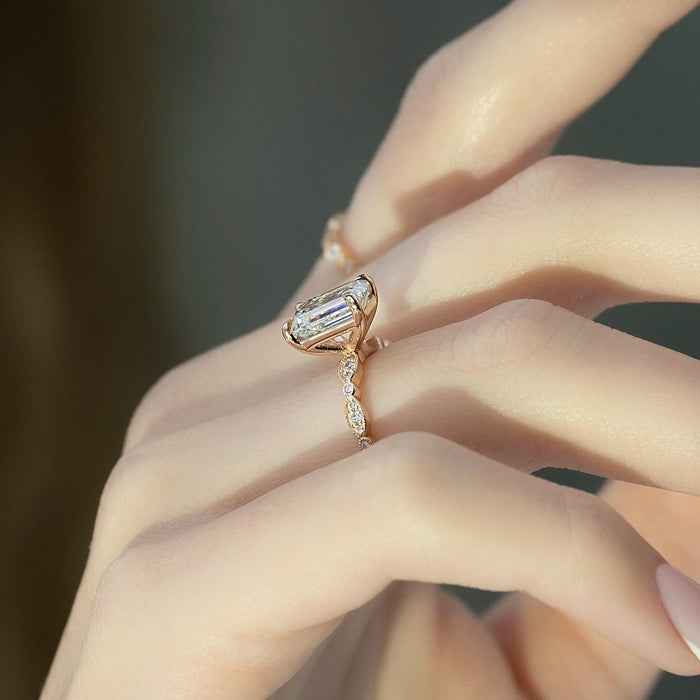 Side view showing the flared open basket beneath the emerald cut diamond
