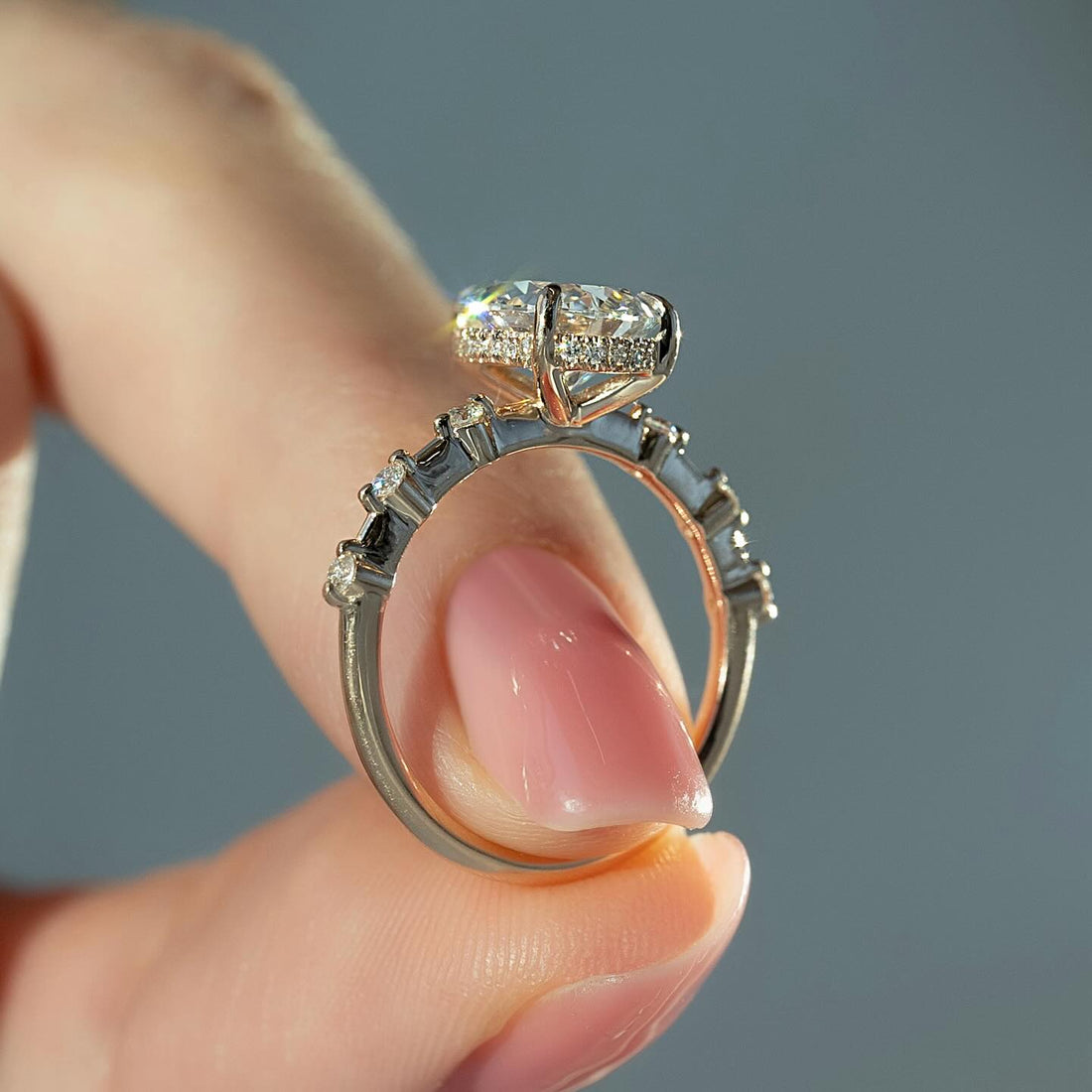 Pear cut lab grown diamond ring with hidden halo and graduated shoulder diamonds