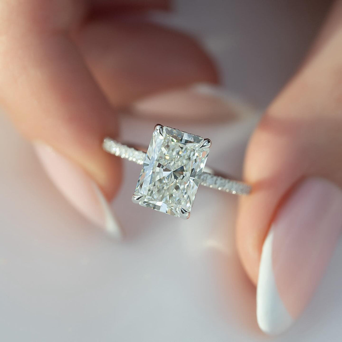 Radiant cut lab grown diamond ring with micro pave shank and hidden halo in white gold