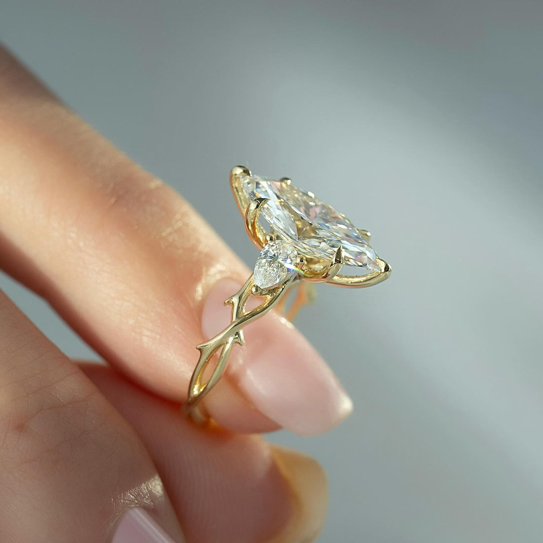 Marquise cut lab grown diamond three stone ring on a yellow gold thorn and vine band
