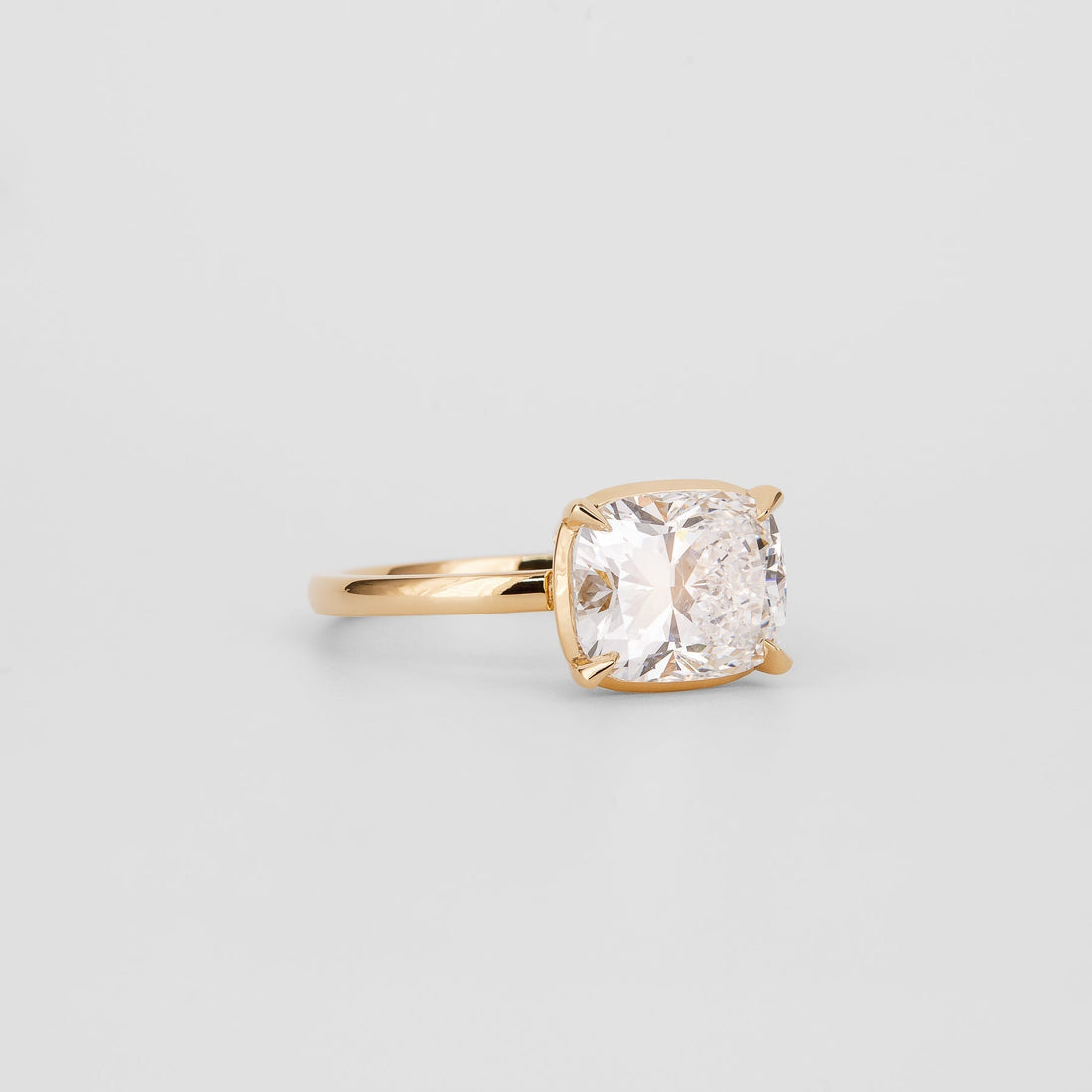 East west elongated cushion cut lab grown diamond solitaire ring in yellow gold