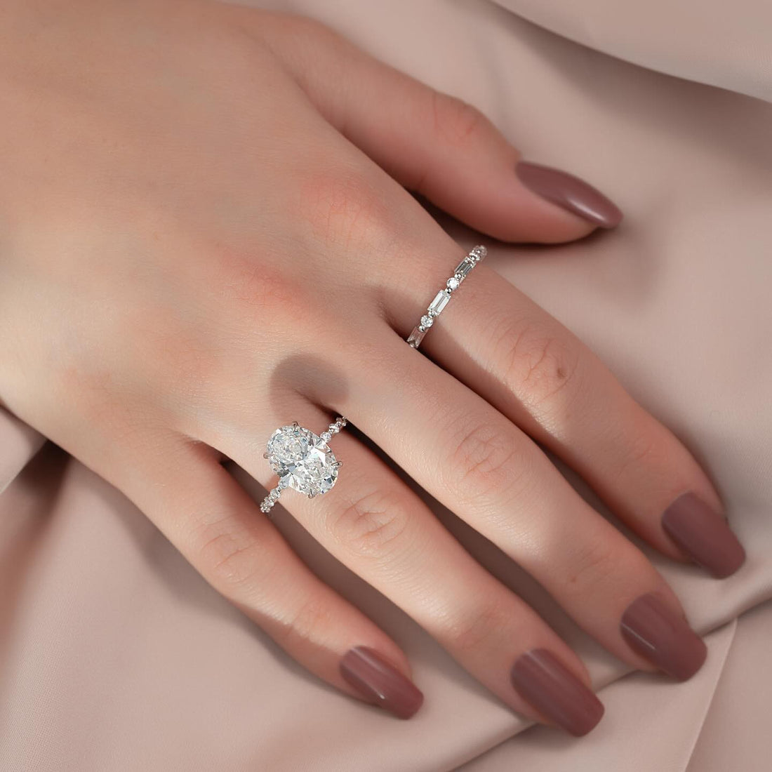 Oval cut lab grown diamond ring with double row hidden halo in white gold worn on the hand