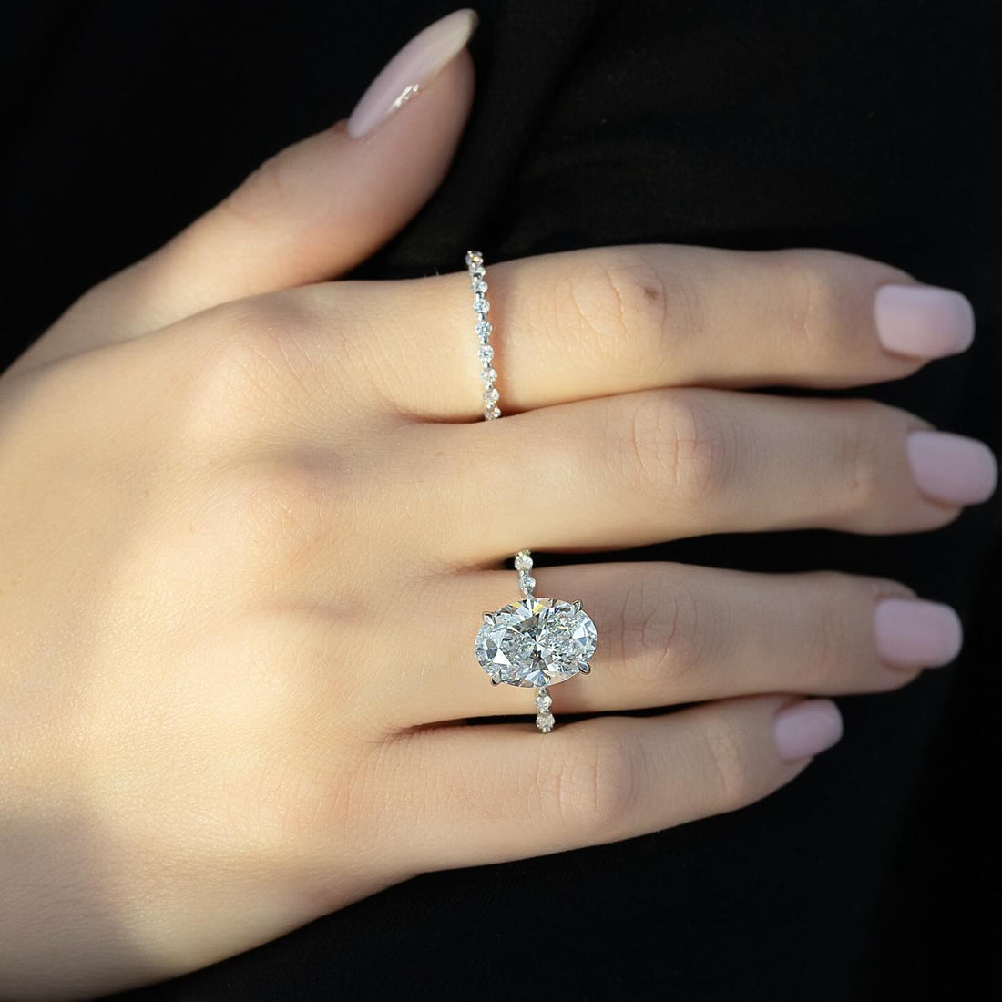 East west oval cut lab grown diamond ring with hidden halo and spaced accents in white gold