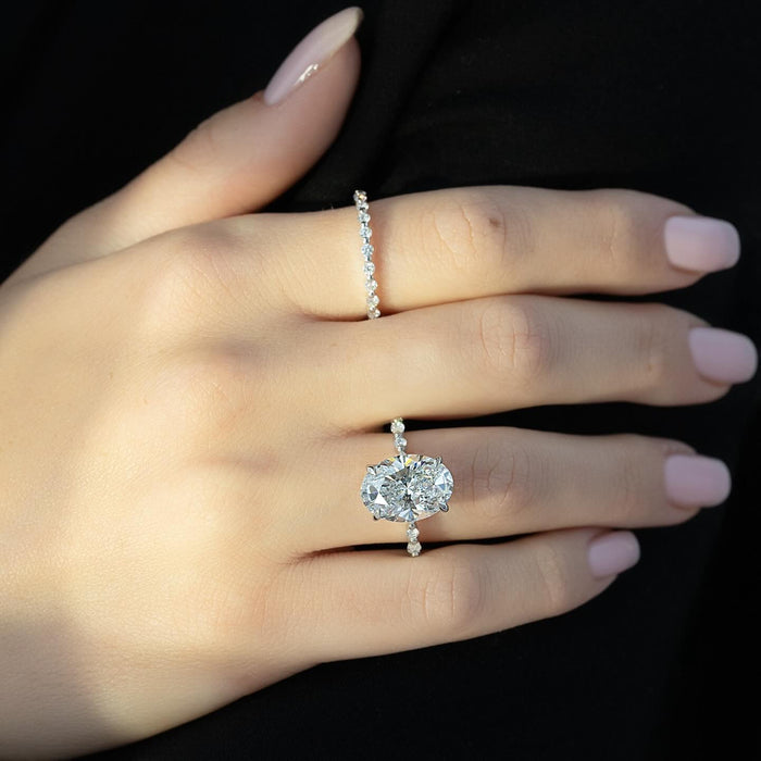 East west oval cut lab grown diamond ring with hidden halo and spaced accents in white gold