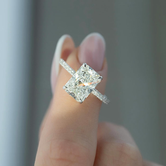 Radiant cut lab grown diamond ring in white gold with a hidden halo and pave shank