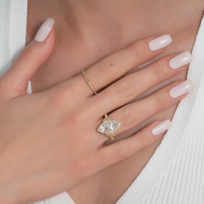 Vintage marquise halo engagement ring worn on the hand